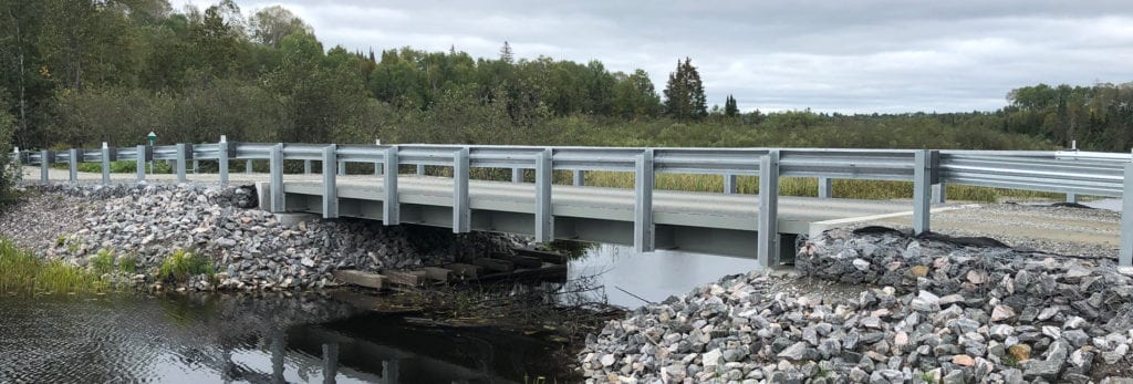 Painted steel girder bridge stream crossing