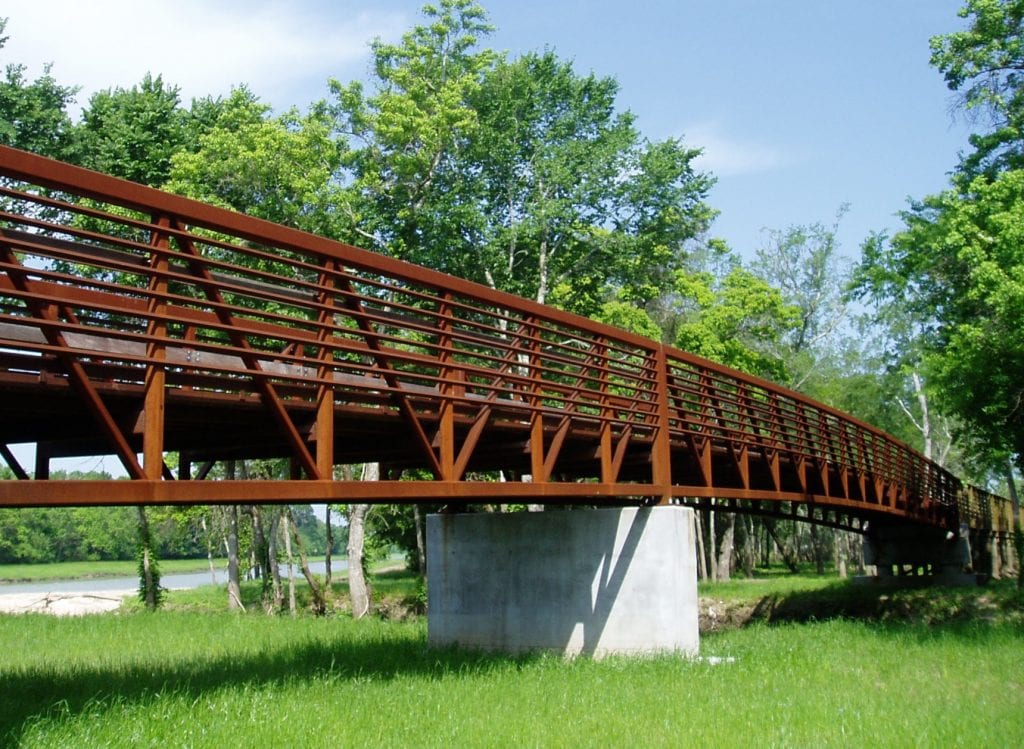 Longer golf cart bridge with concrete pier over marsh
