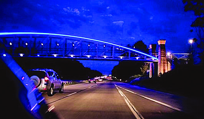 Bowstring truss pedestrian bridge design with architectural lighting