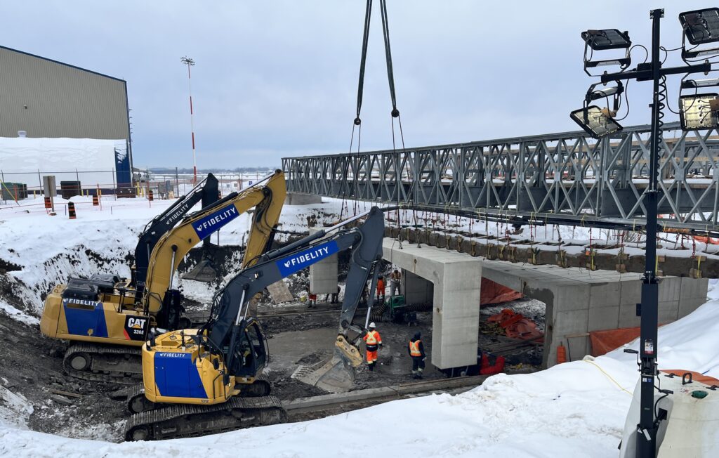 Precast concrete culvert installed under utility pipe bridge