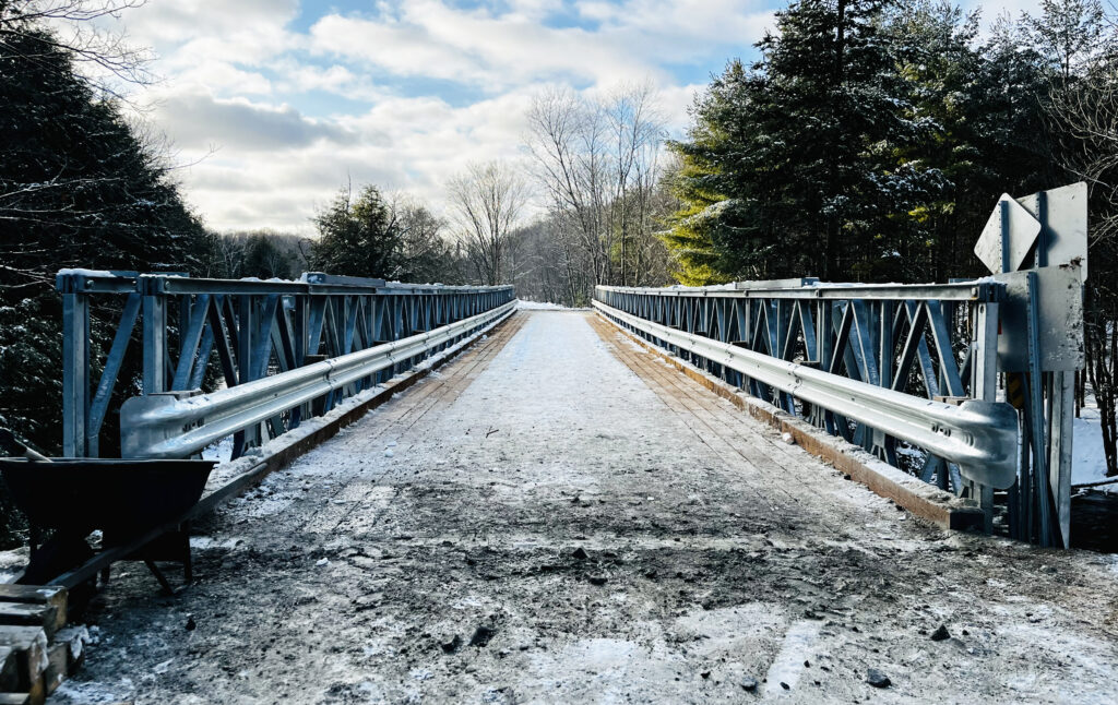 Wide view of Bailey-Bridge-style snowmobile trail bridge