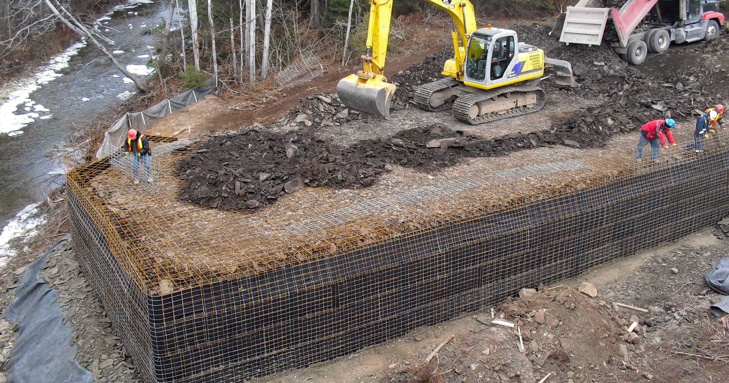 aerial view of preparation of site where steel girder bridge will cross a stream