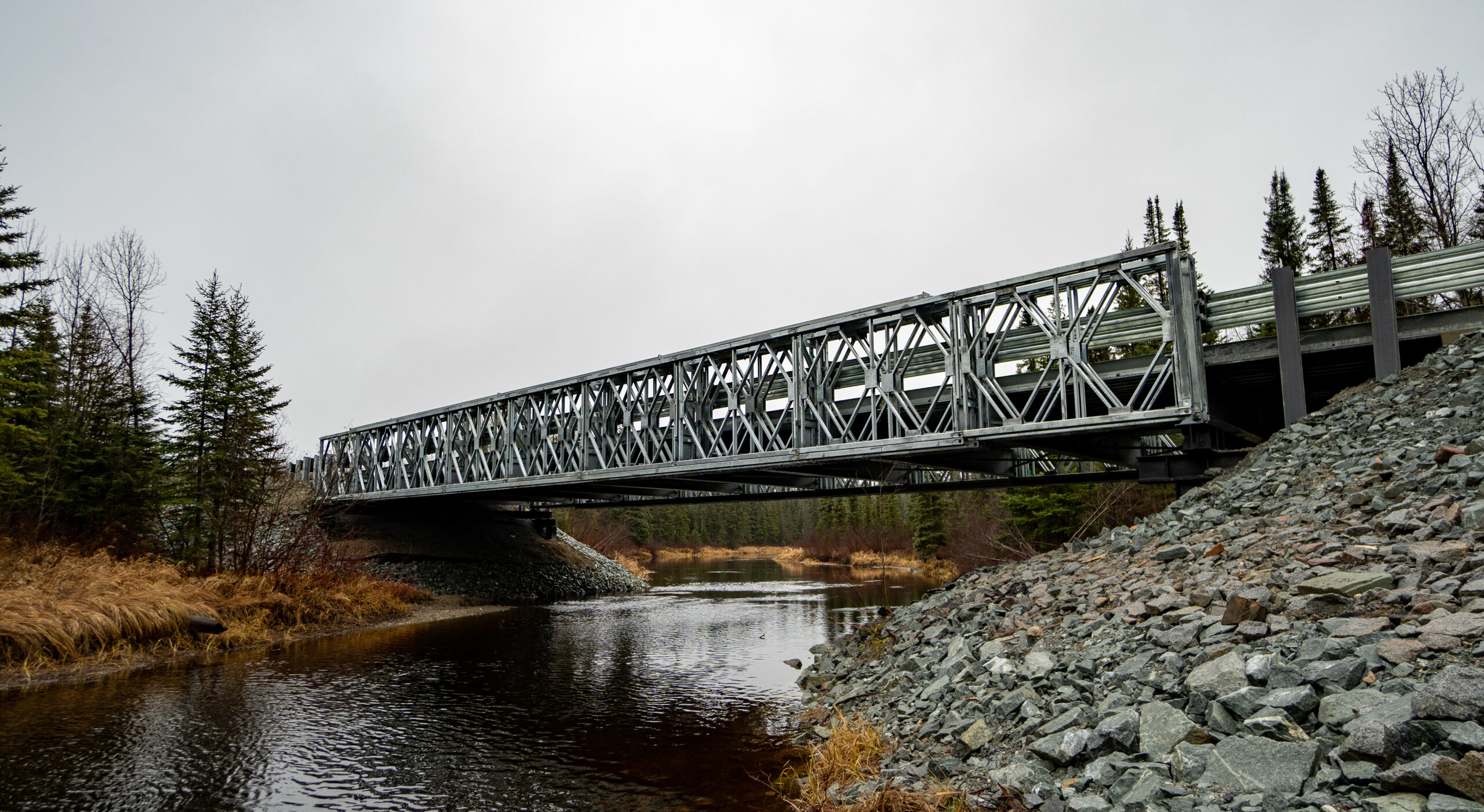 Angled view of completed Algonquin R800 Modular Panel Bridge crossing a stream